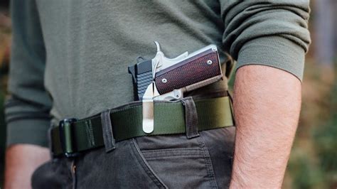 A 1911 handgun in a concealed carry holster