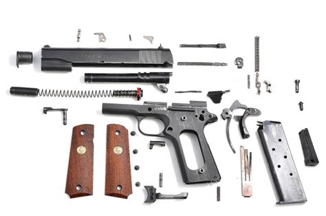 A disassembled 1911 pistol showing its internal components