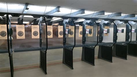 A person shooting a 22 pistol at a shooting range