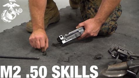 A soldier performing maintenance on a 50 cal machine gun