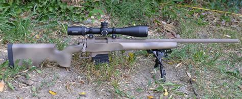 A shooter engaging targets at extended ranges with a 6.5 Creedmoor rifle