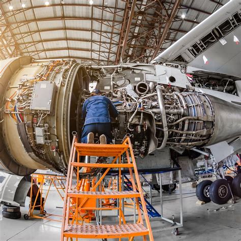 Aircraft Maintenance Specialists working on a cargo plane