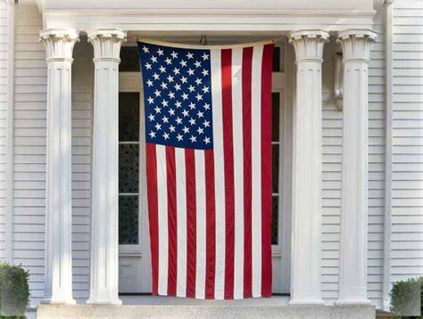 A photo of the American flag being displayed at a military base