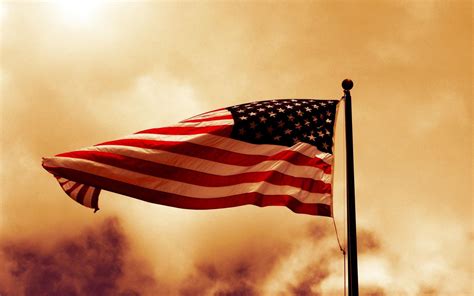 A photo of the American flag being displayed at a military ceremony