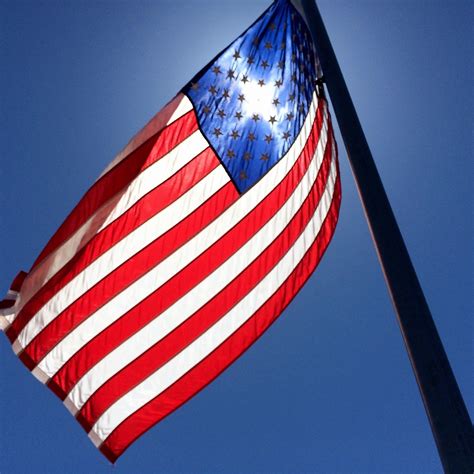 A photo of the American flag being displayed at a patriotic event