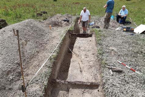 Archaeologists excavating a rifle