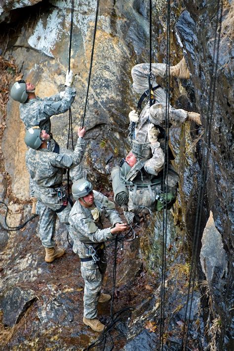 Army Rangers rappelling down a cliff