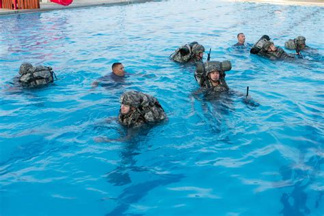 Army Rangers swimming in a lake