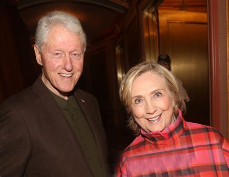 Bill and Hillary Clinton waving at a crowd