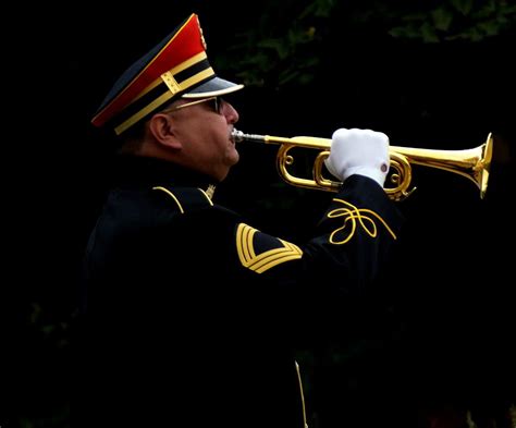 A bugler playing Taps at sunset