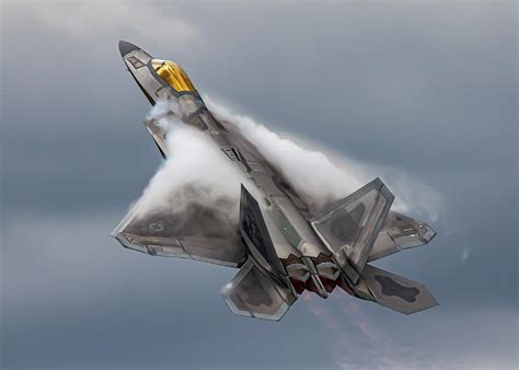 F-22 Raptor flying through clouds