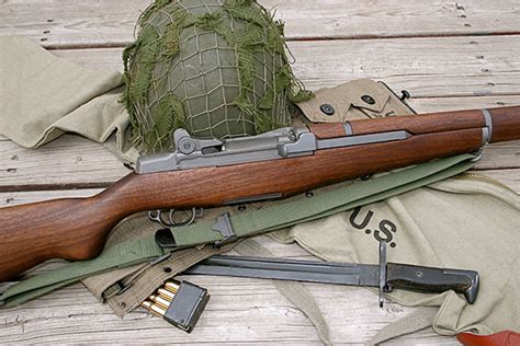 Collection of M1 Garand rifles on display at a gun show