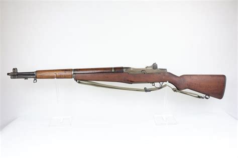 Collection of M1 Garand rifles on display at a gun show