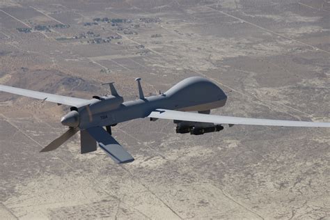 MQ-1C Gray Eagle UAV in flight over desert terrain