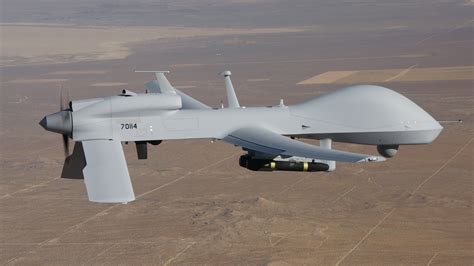 MQ-1C Gray Eagle UAV in flight over desert terrain