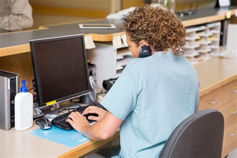 Medical Records Technician Working on Computer