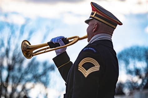 A military bugler playing taps