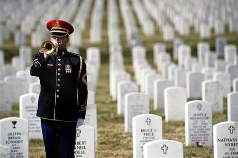 A military funeral with a bugler playing Taps