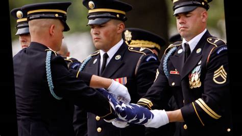 A military funeral with a bugler playing Taps