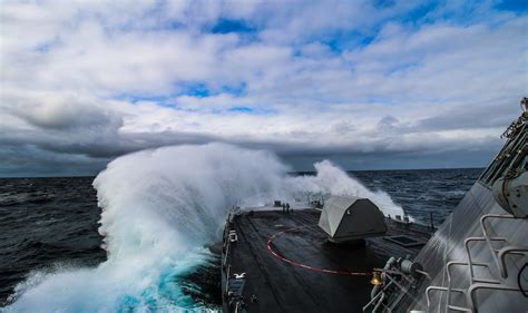 Navy crew navigating rough seas