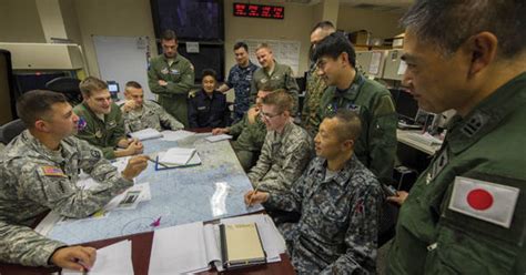 Navy Operations Specialists planning a mission