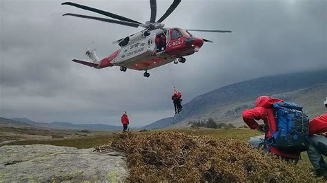 Helicopter rescuing a sailor from the water