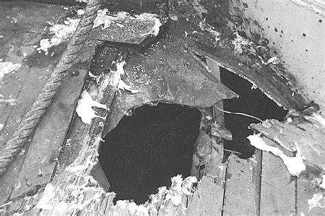 USS Wisconsin's crew inspecting damage