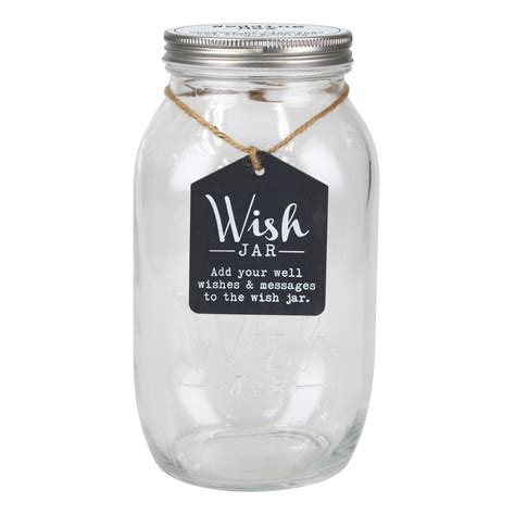 A photo of a wish jar filled with notes, surrounded by candles and stars