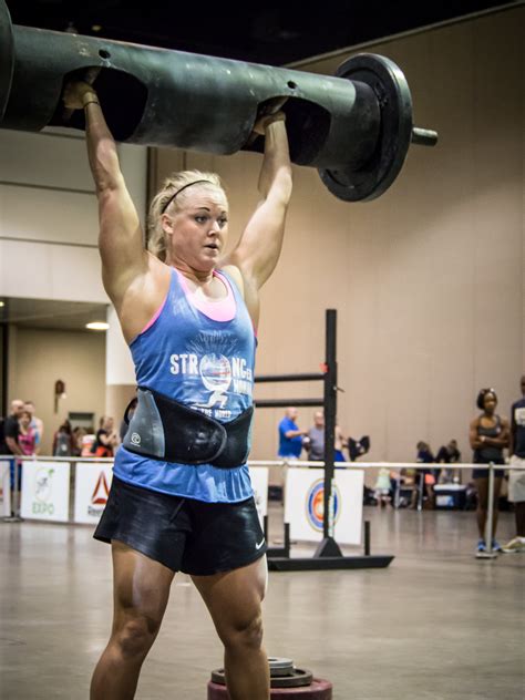 Women participating in strength competitions, lifting and carrying each other