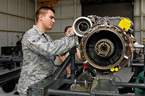 An Air Force airplane mechanic working on a propeller