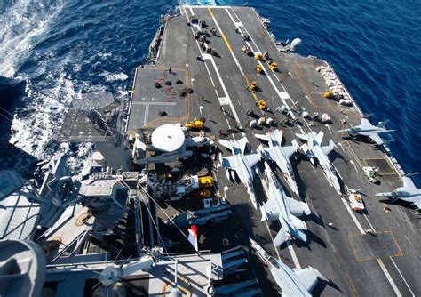 Coast Guard personnel participating in a training exercise on an aircraft carrier