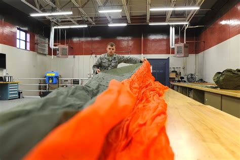 Aircrew Flight Equipment Specialist inspecting parachutes