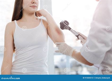 An allergist examining a patient