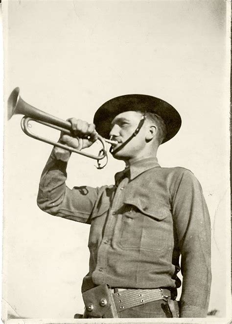 A soldier blowing a bugle during a ceremony