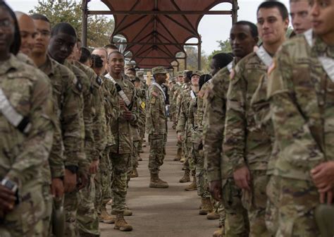 A group of soldiers in uniform, with their arms around each other