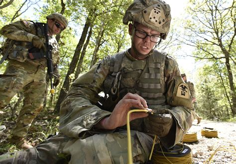 A group of soldiers in uniforms, with engineering equipment