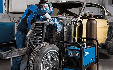 Welder working on a car