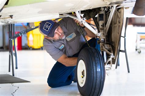 Avionics Technician Inspecting Aircraft