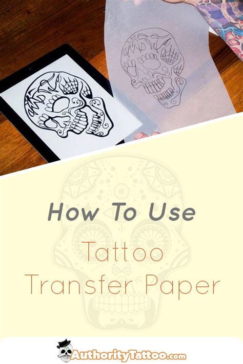 Tattoo artist at work with transfer paper