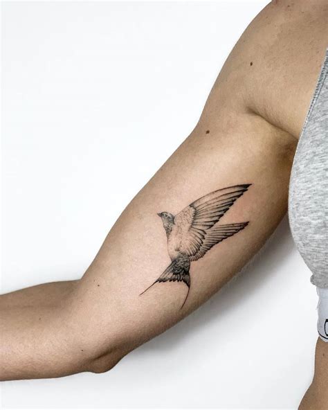 Bird upper arm tattoos