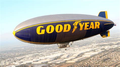 Blimp in flight over a landscape