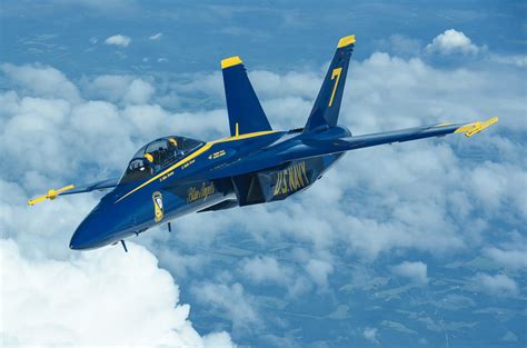 Blue Angels F-18 flying in formation with other aircraft