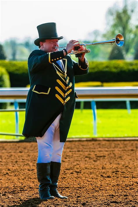 Bugler playing the bugle at a horse racing event