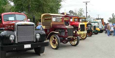 A vintage chicken feed truck on display at a classic car show