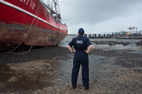 Coast Guard members working in a shore-based office