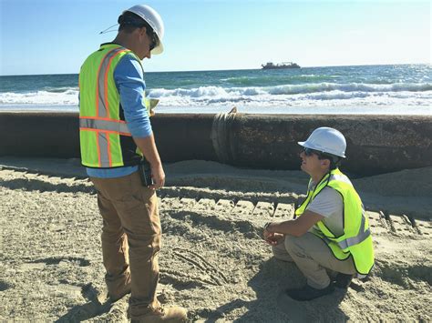 Coastal engineer designing a seawall