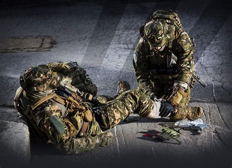 Combat medic providing aid to a wounded soldier