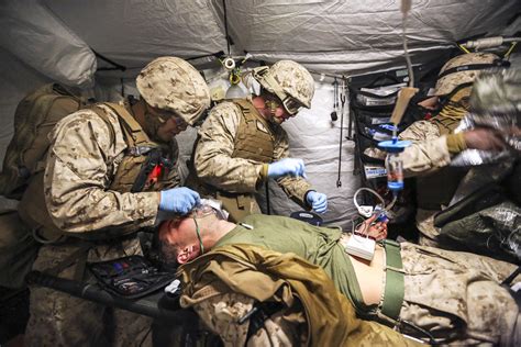 Combat medic providing medical aid in a war zone