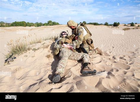 Combat Medic treating wounded soldier