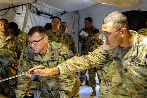 A commander in training, with a simulator or other training device in the background